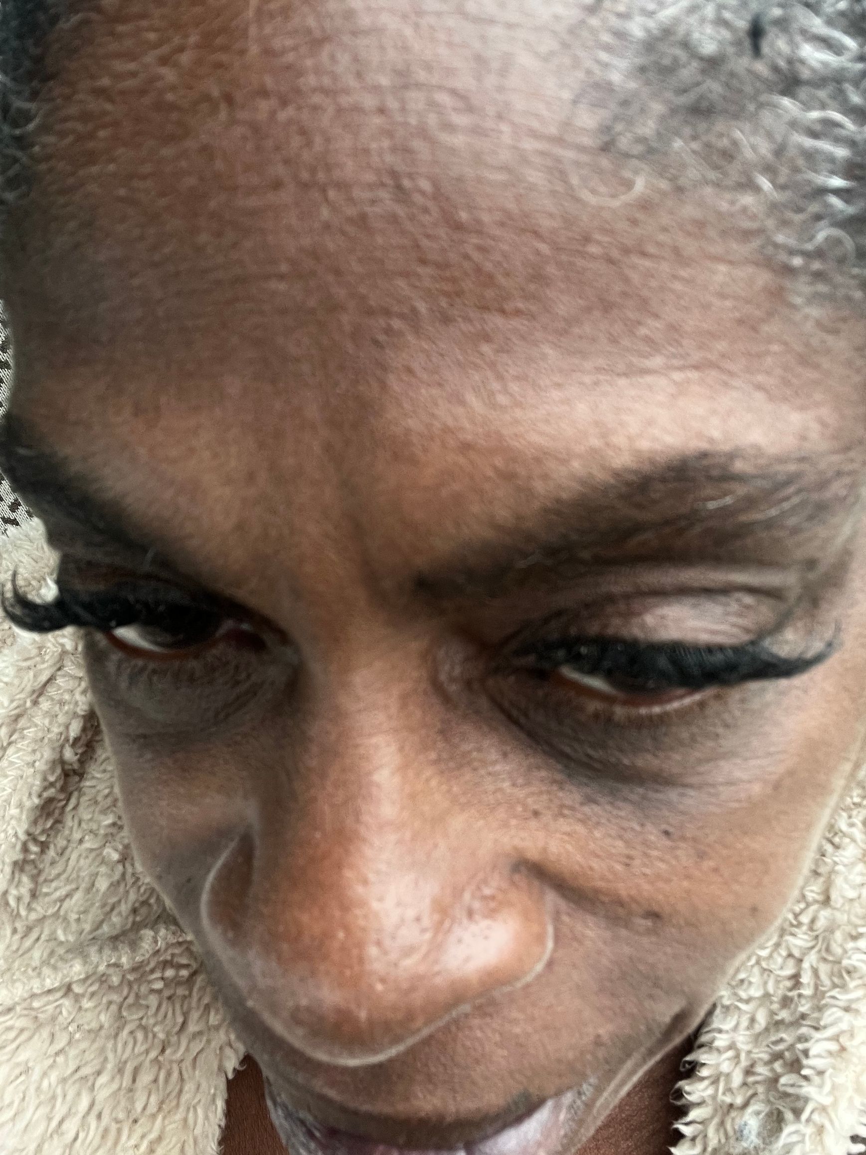 A close-up of a person's face with eyes closed.