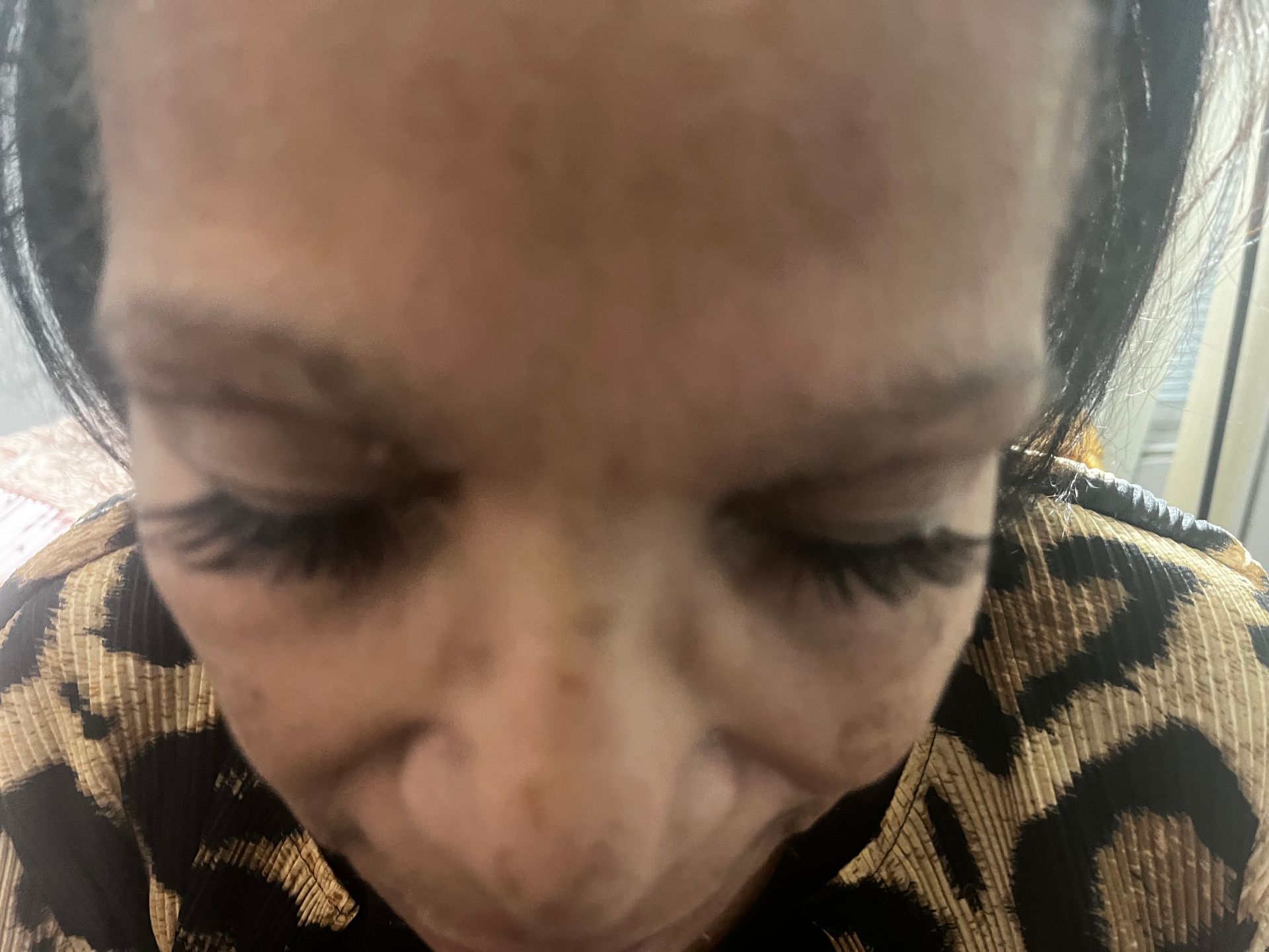 A close-up of a person's face with eyes closed.