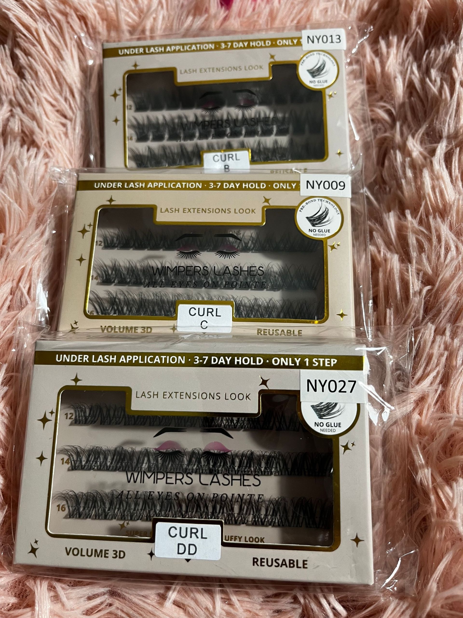 Three boxes of individual false eyelashes labeled