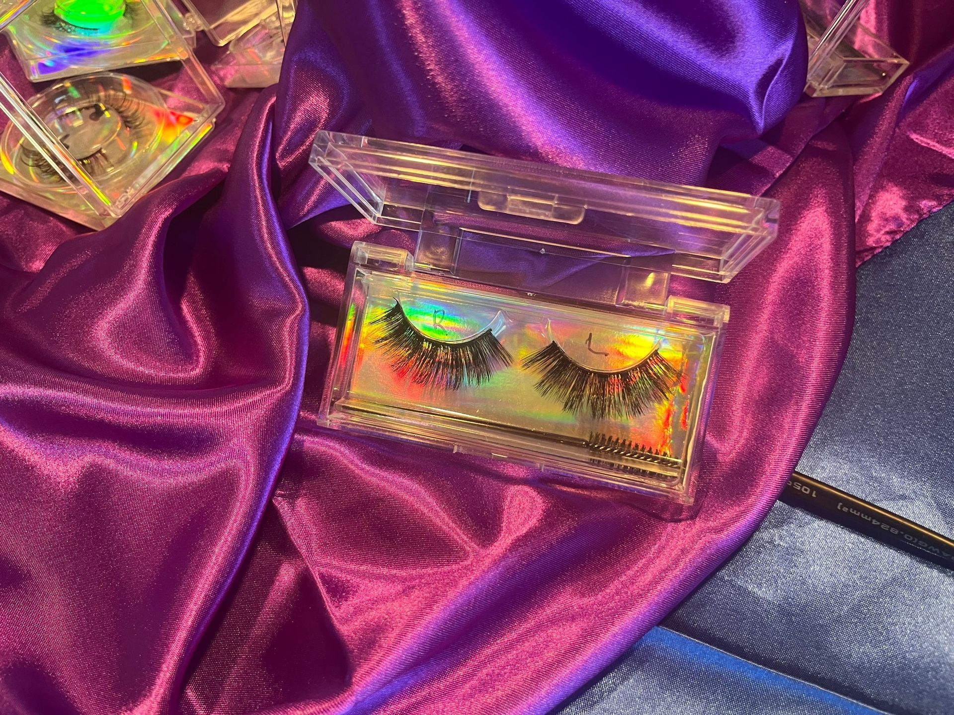 False eyelashes in a clear case on purple satin.