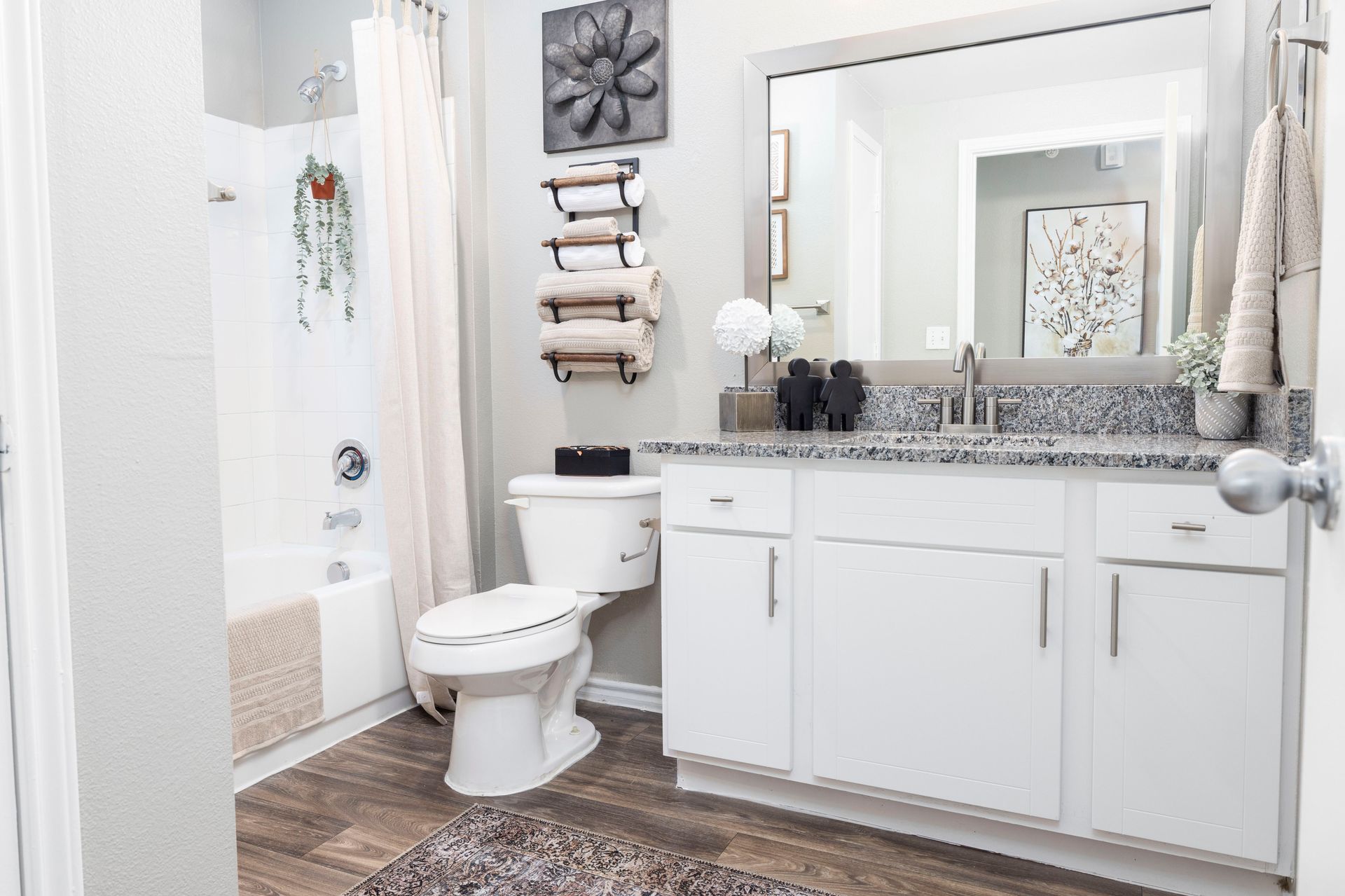 A bathroom with a toilet , sink , and mirror.