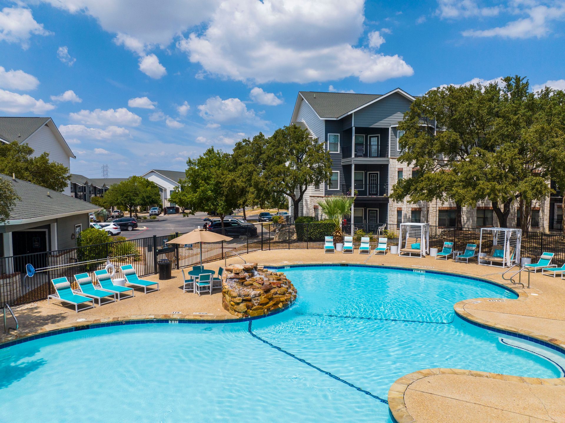 A large gym with a lot of exercise equipment and a bench.