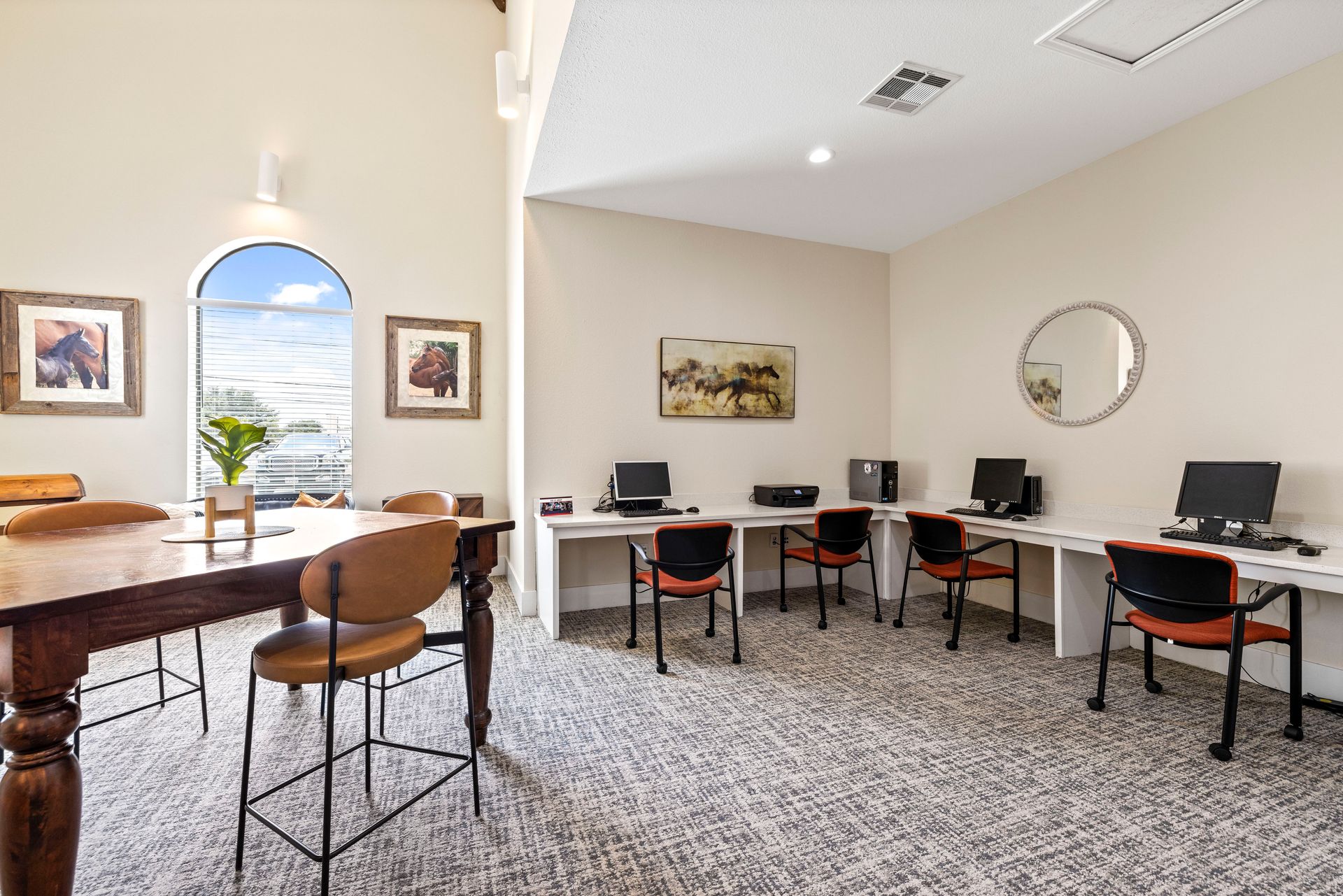 An aerial view of a basketball court in a parking lot in front of a building.