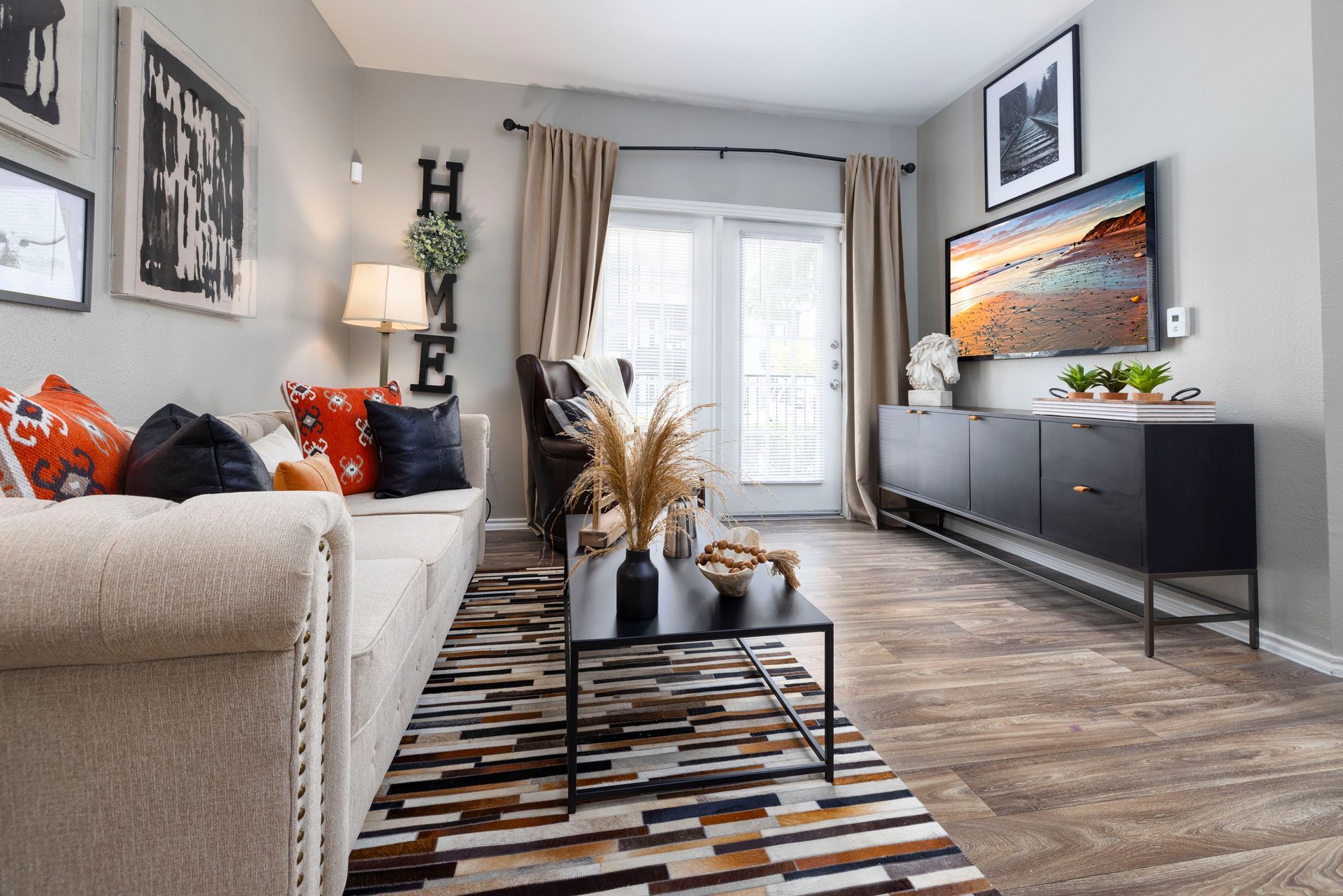 A living room with a couch , coffee table , and television.