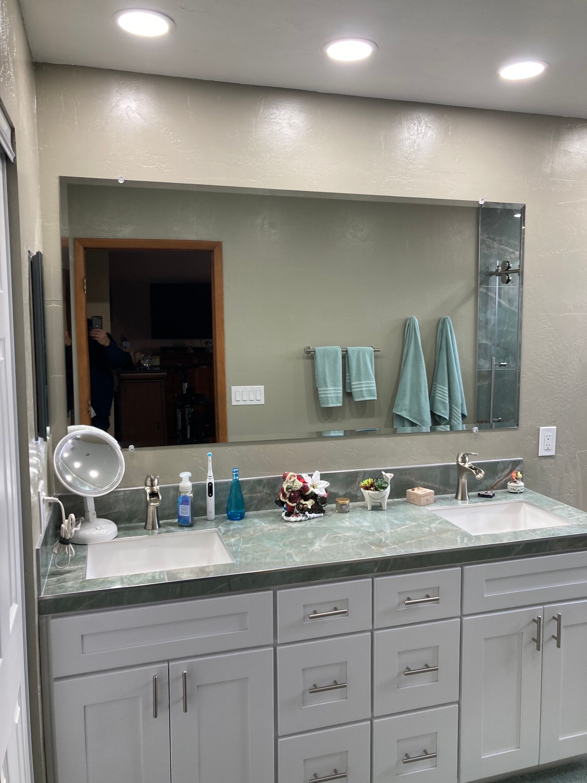 A bathroom with two sinks and a large mirror.