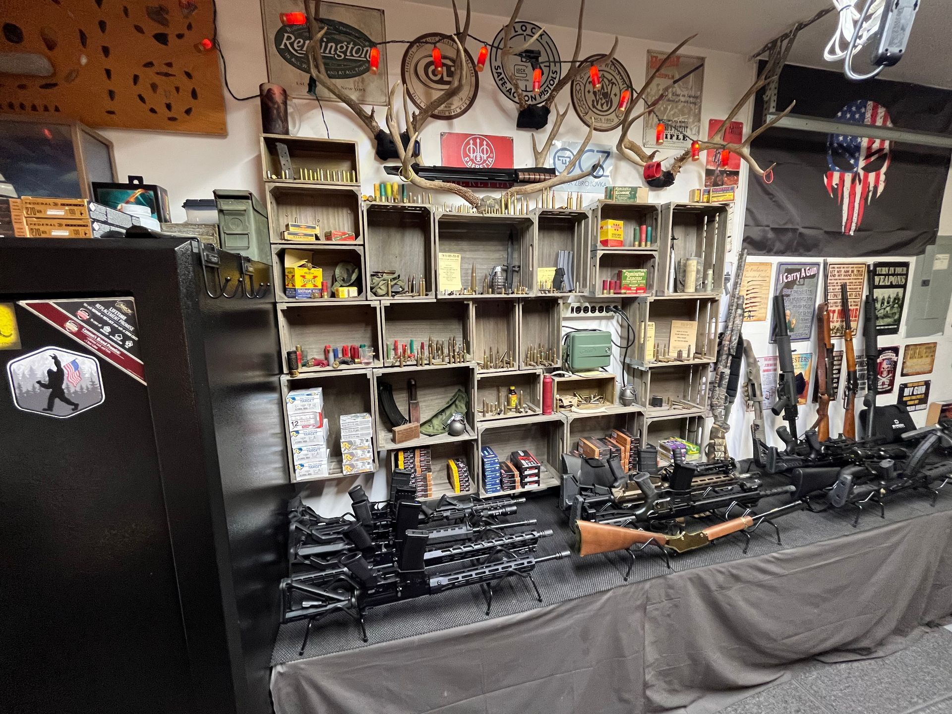 A gun shop display with rifles, ammunition, and hunting decor.