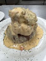 A white plate topped with ravioli and garlic bread