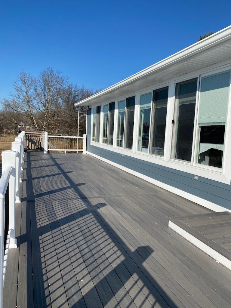 A large house with a large deck in front of it