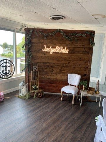 A room with a wooden wall and a chair in front of it.