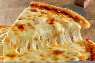 A close up of a slice of cheese pizza on a table.