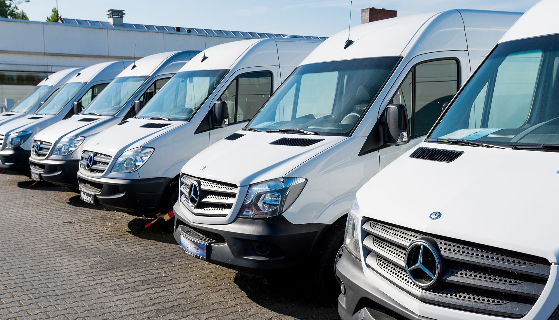House under renovation, with paint cans and ladders. Exterior has white and brown sections.