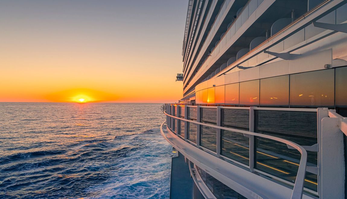 House under renovation, with paint cans and ladders. Exterior has white and brown sections.