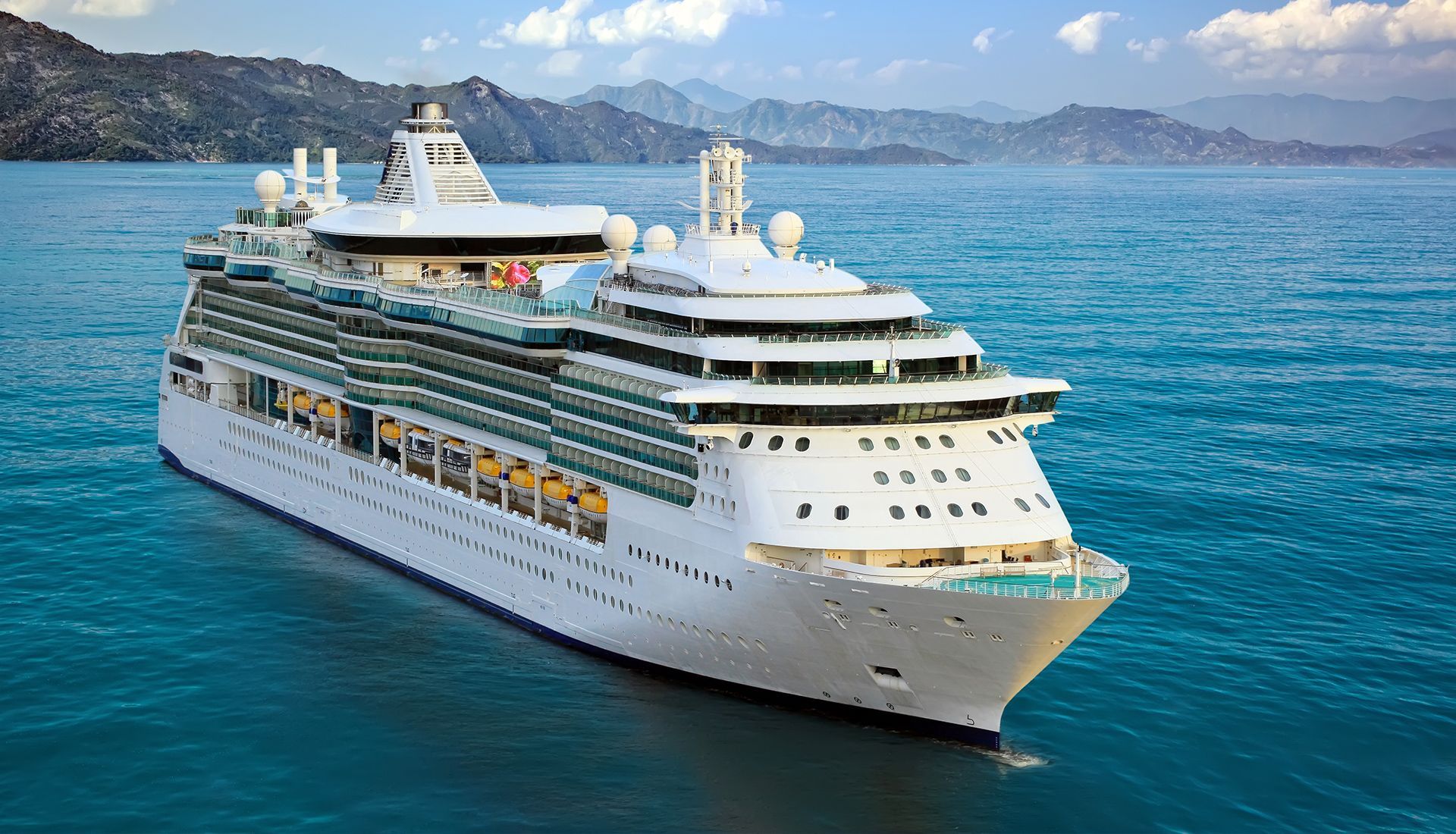 House under renovation, with paint cans and ladders. Exterior has white and brown sections.