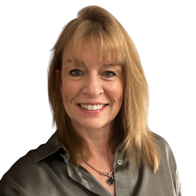 A woman wearing a grey shirt and a necklace smiles for the camera