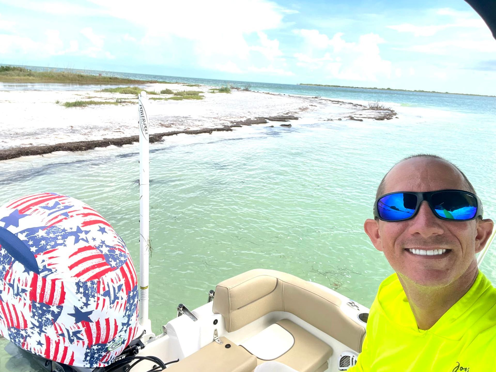 A man is taking a selfie on a boat in the ocean.