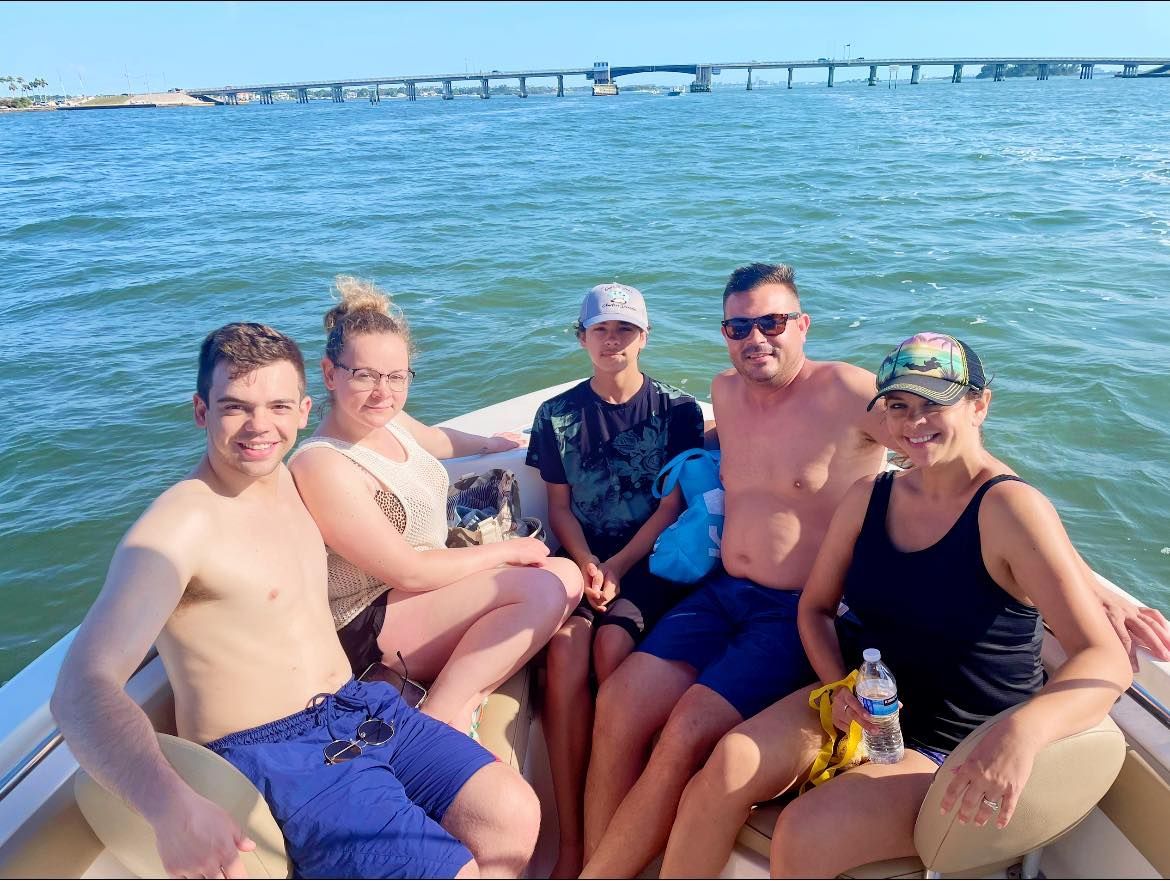 A group of people are sitting on a boat in the water.