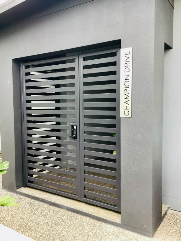 A Metal Gate With A Sign That Says Champion Drive On It — Ward's Aluminium in Charter Towers, QLD