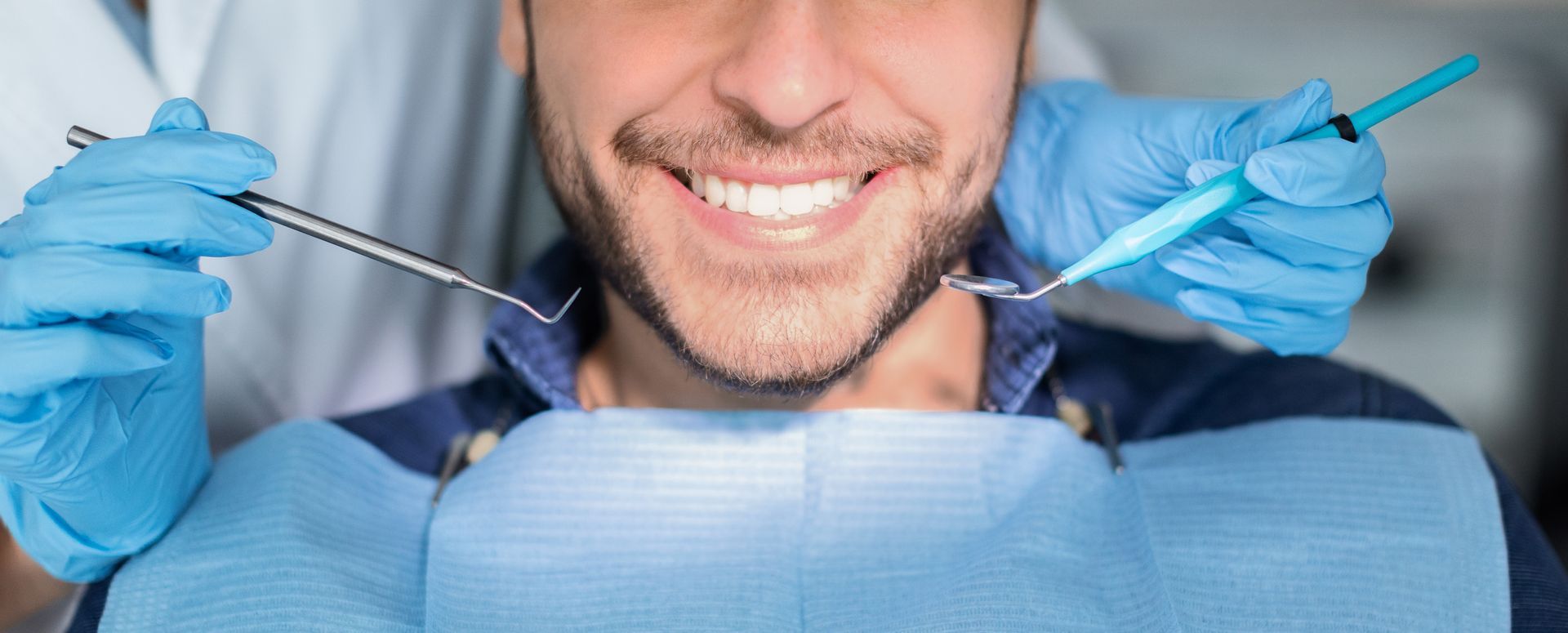 Smiling male patient in dental chair