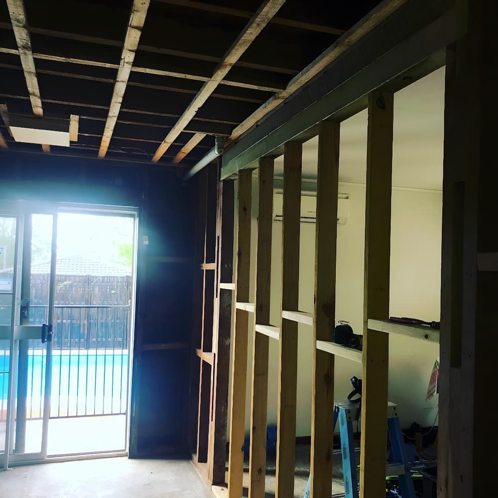 A Room Under Construction With a Sliding Glass Door and a Pool in the Background — Veramax Industries in Park Avenue, QLD