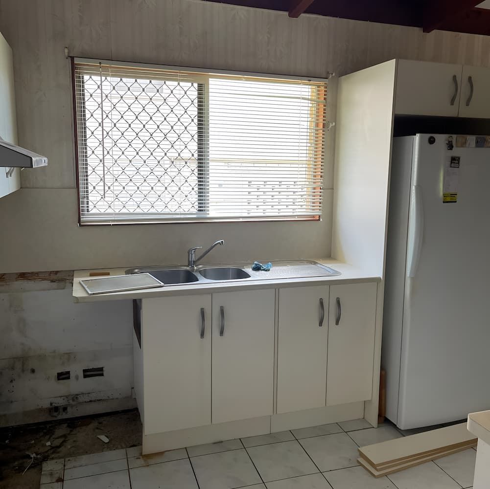 A Kitchen With White Cabinets and a White Refrigerator — Veramax Industries in Park Avenue, QLD