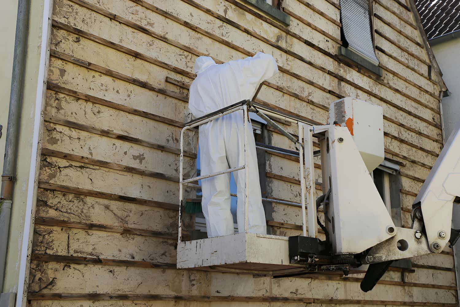 A Man in a White Suit is Standing in a Bucket on the Side of a Building — Veramax Industries in Park Avenue, QLD