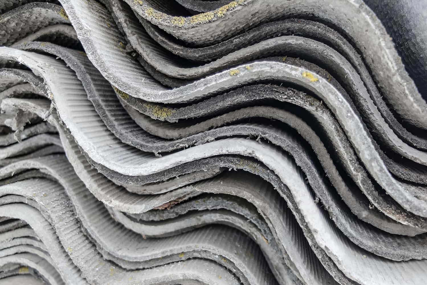 A Close Up of a Pile of Asbestos Sheets Stacked on Top of Each Other — Veramax Industries in Whitsundays, QLD