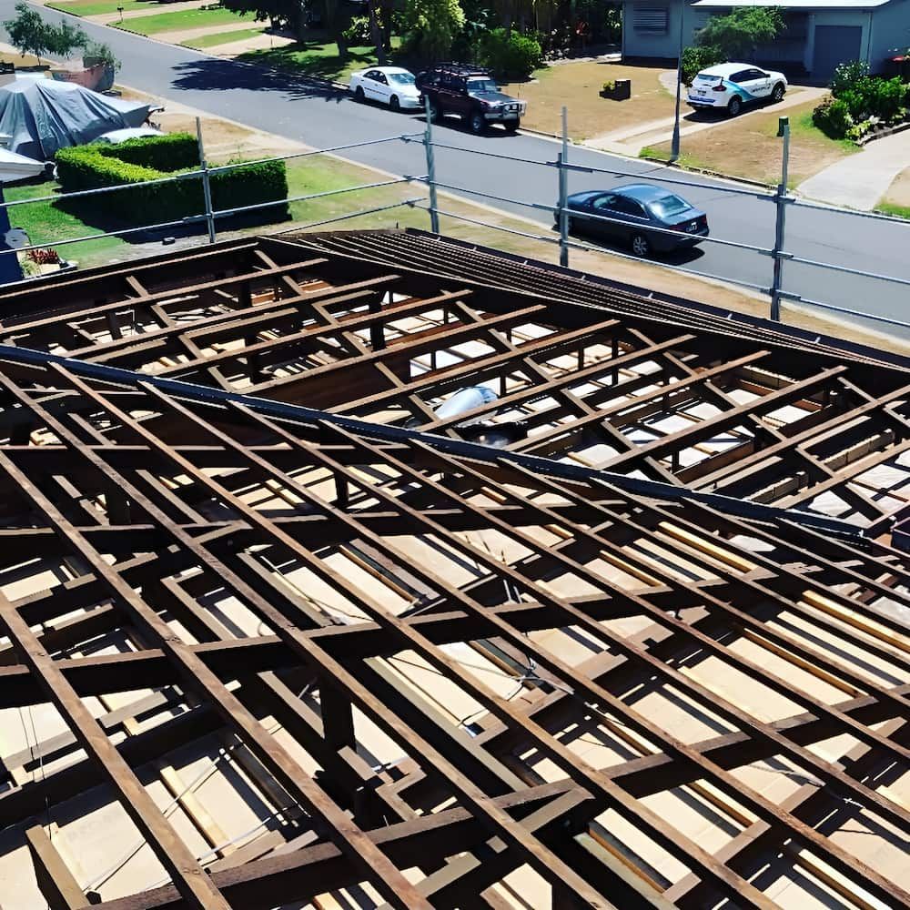 The Roof of a House is Being Demolished and a Car is Parked on the Side of the Road — Veramax Industries in Rockhampton, QLD