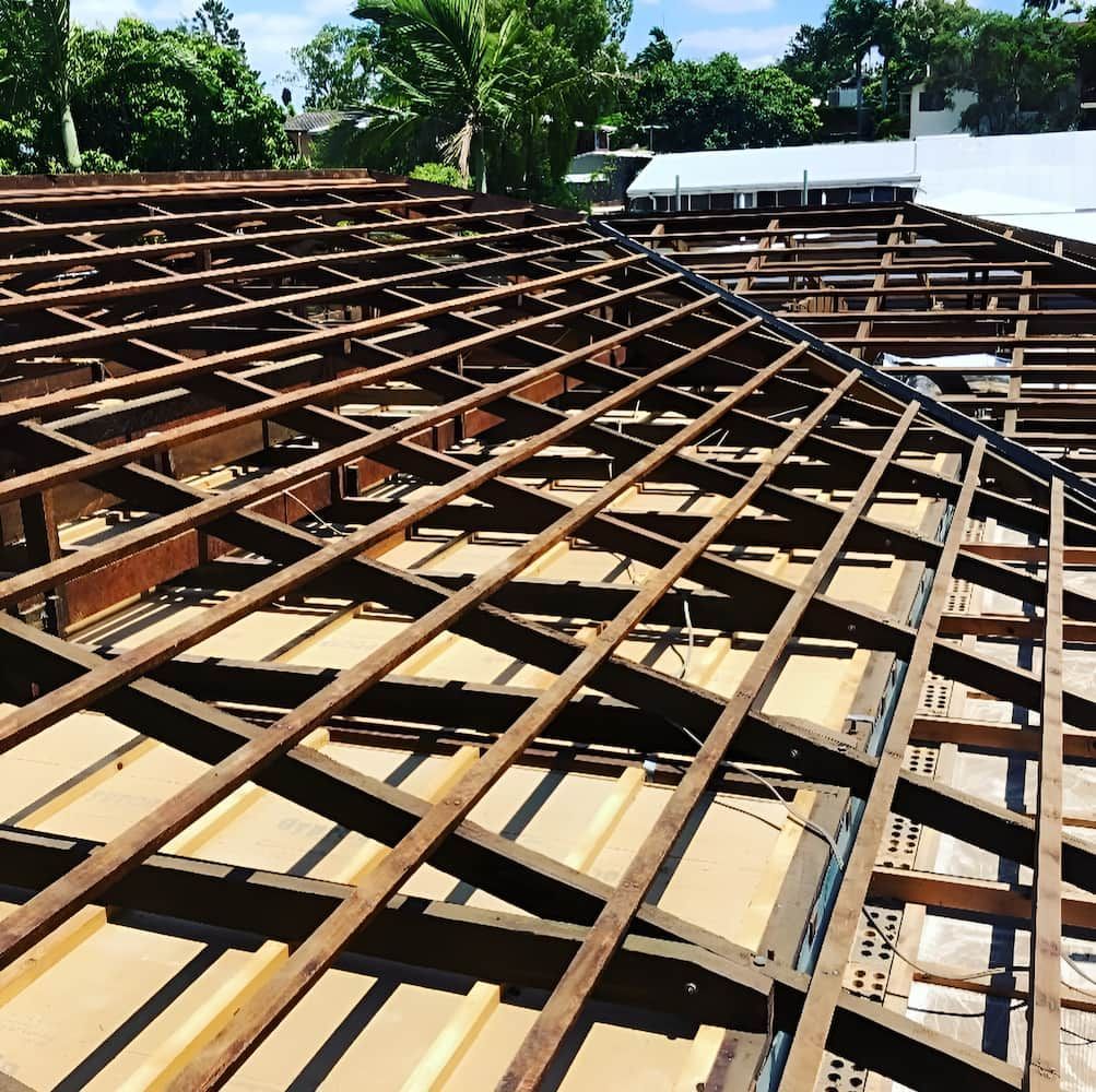 The Roof of a Building is Being Built With Wooden Beams — Veramax Industries in Gladstone, QLD