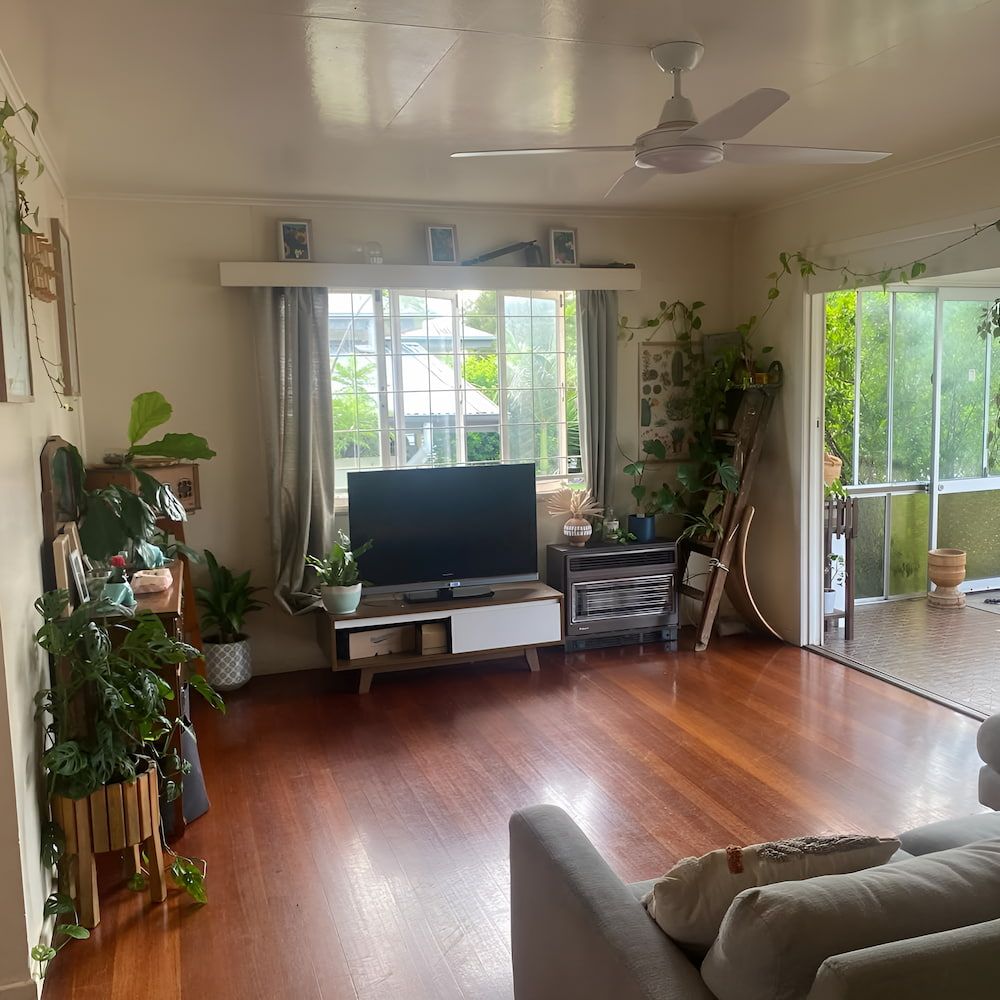 A Living Room With a Couch, Television, and a Ceiling Fan — Veramax Industries in Park Avenue, QLD
