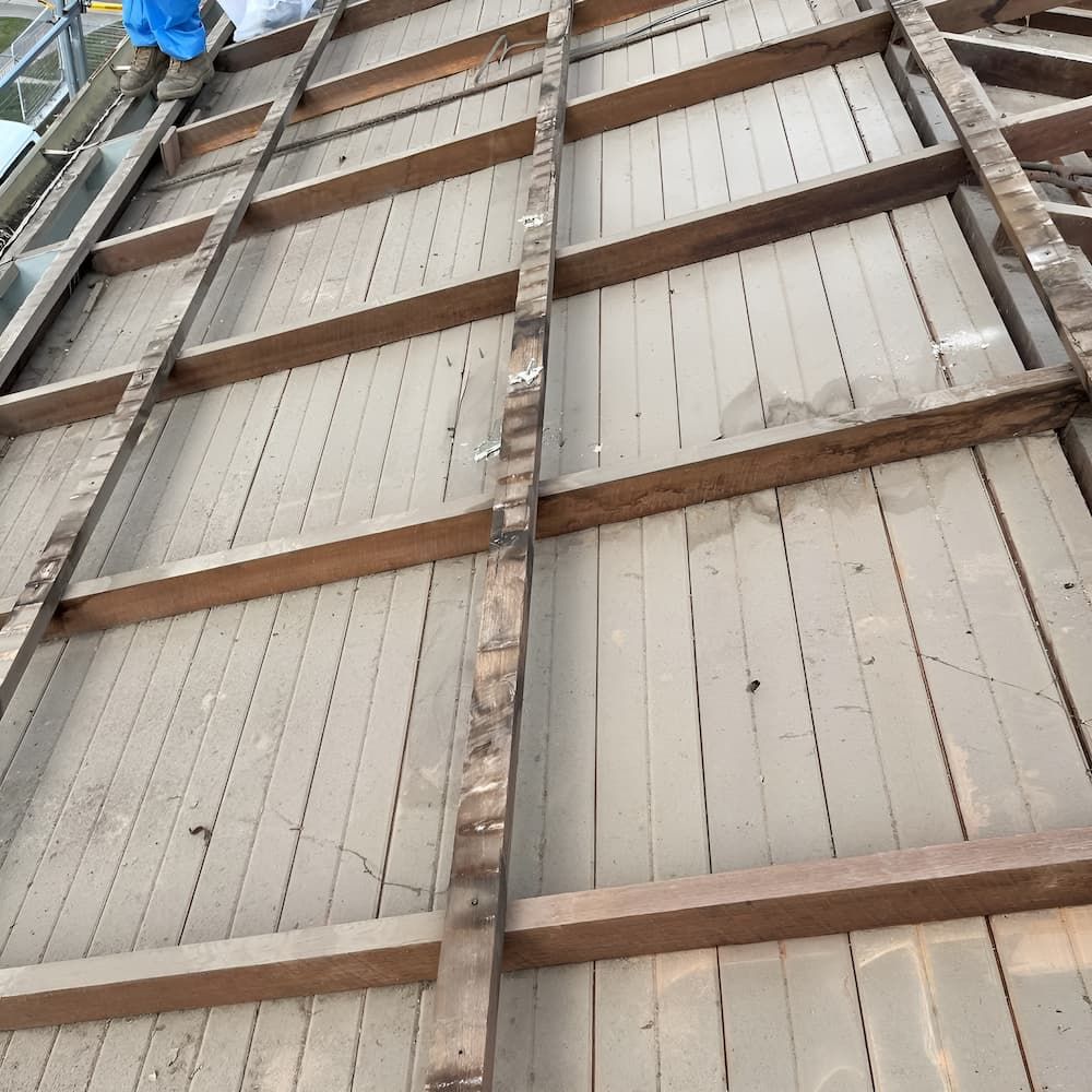 A Person is Standing on Top of a Wooden Roof — Veramax Industries in Mackay, QLD