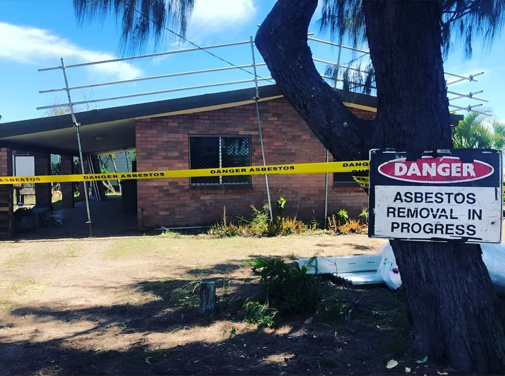 A Sign That Says Danger Asbestos Removal in Progress — Veramax Industries in Park Avenue, QLD