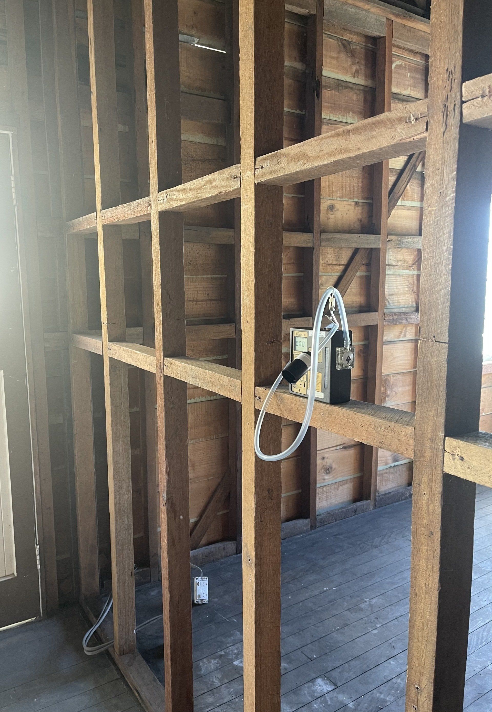 A Person Wearing Blue Gloves is Holding a Tweezer Over a Rock — Veramax Industries in Park Avenue, QLD