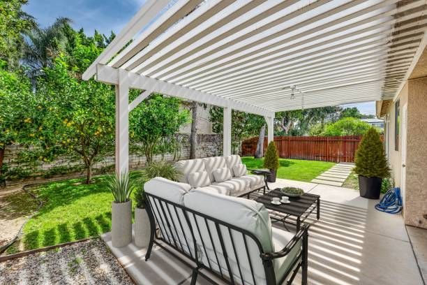 Modern white louvered patio cover over outdoor seating.