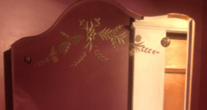 Gold-framed mirror on a marble surface; ornate details, close-up.