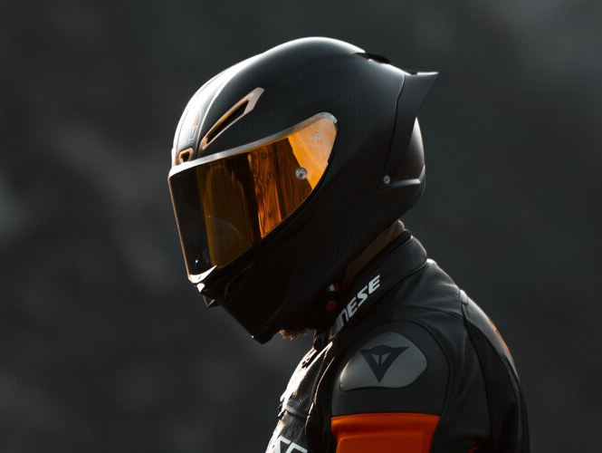 A close up of a person wearing a motorcycle helmet