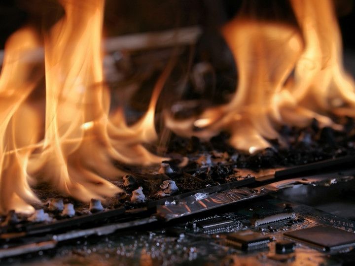 a close up of a motherboard with flames coming out of it .