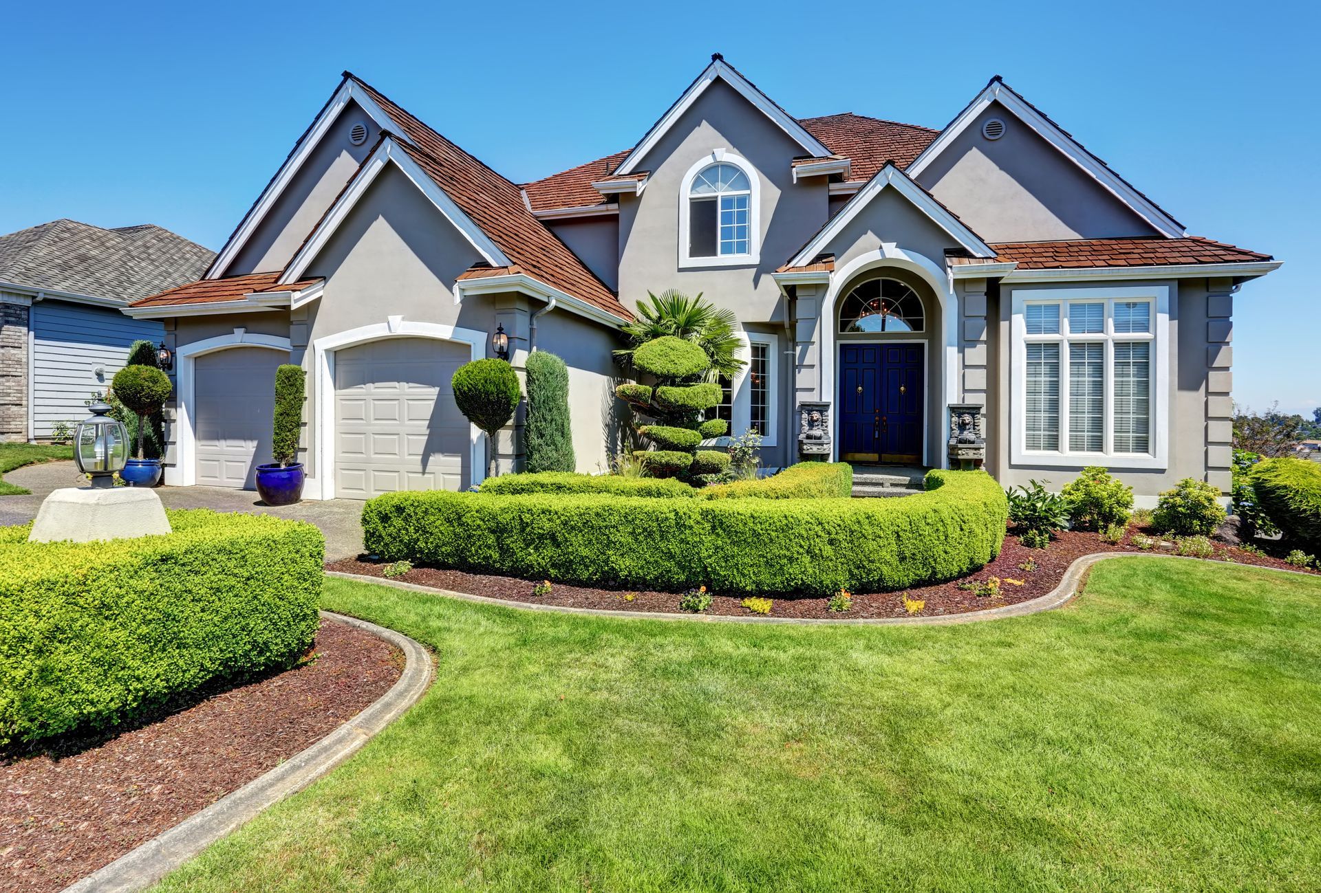 A large house with a lush green lawn in front of it.