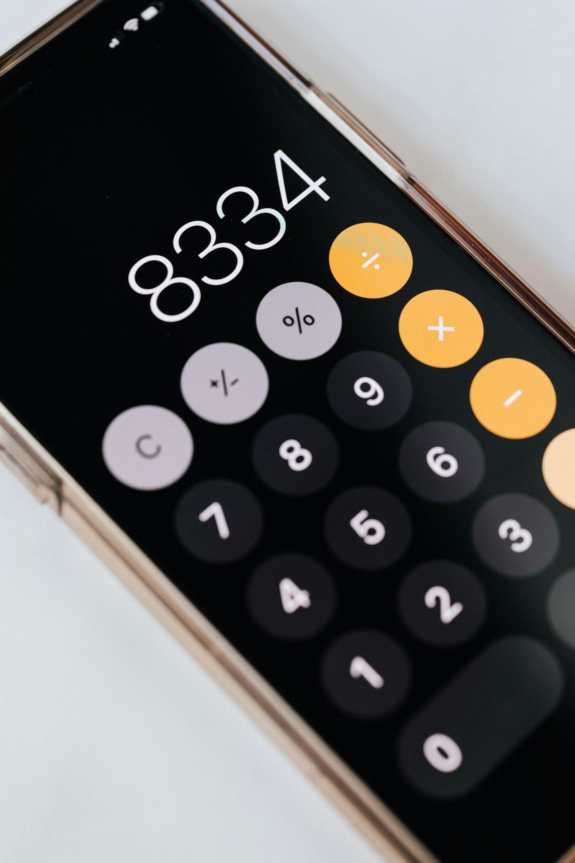 A cell phone with a calculator displaying the number 8334