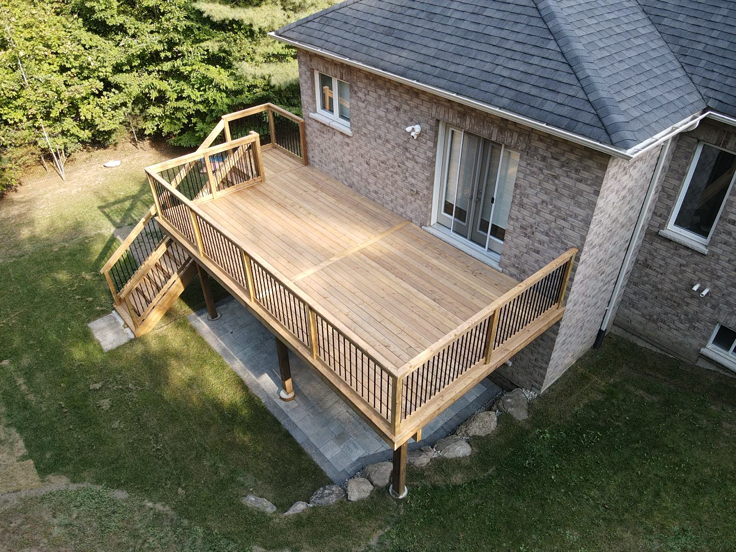 An aerial view of a wooden deck on the side of a house.