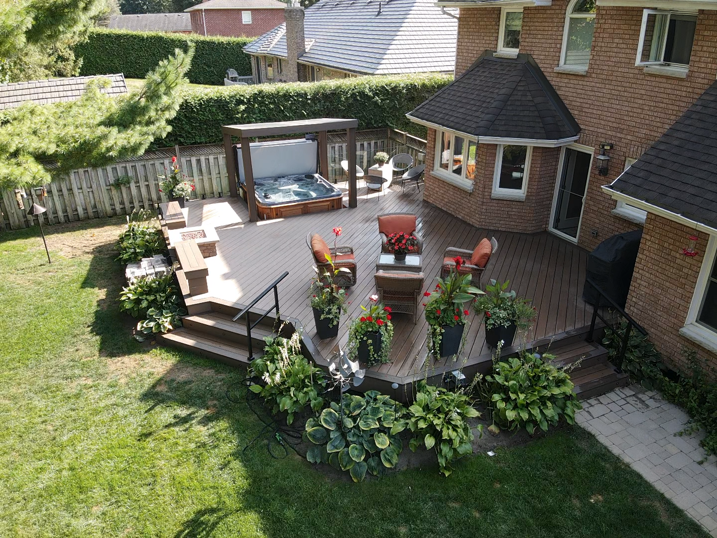 An aerial view of a backyard with a hot tub and patio furniture.
