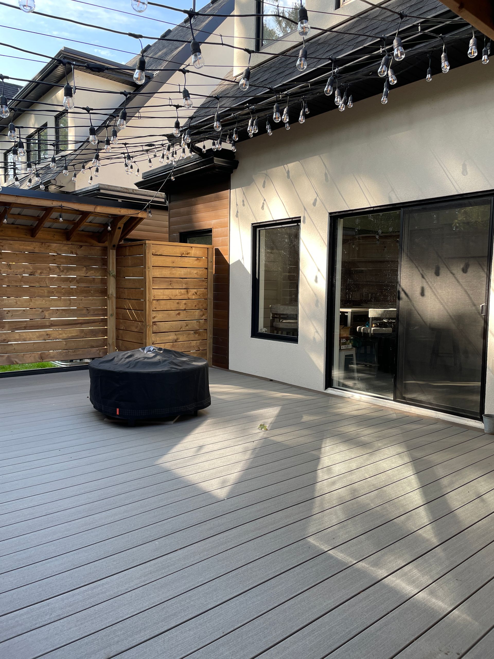 There is a fire pit on the deck of a house.