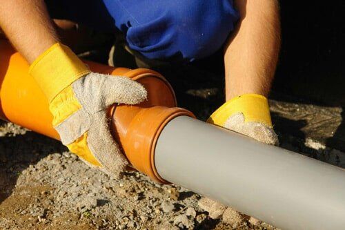 Plumber Working On A PVC Pipe — Plumbing Service in Whitemarsh, MD