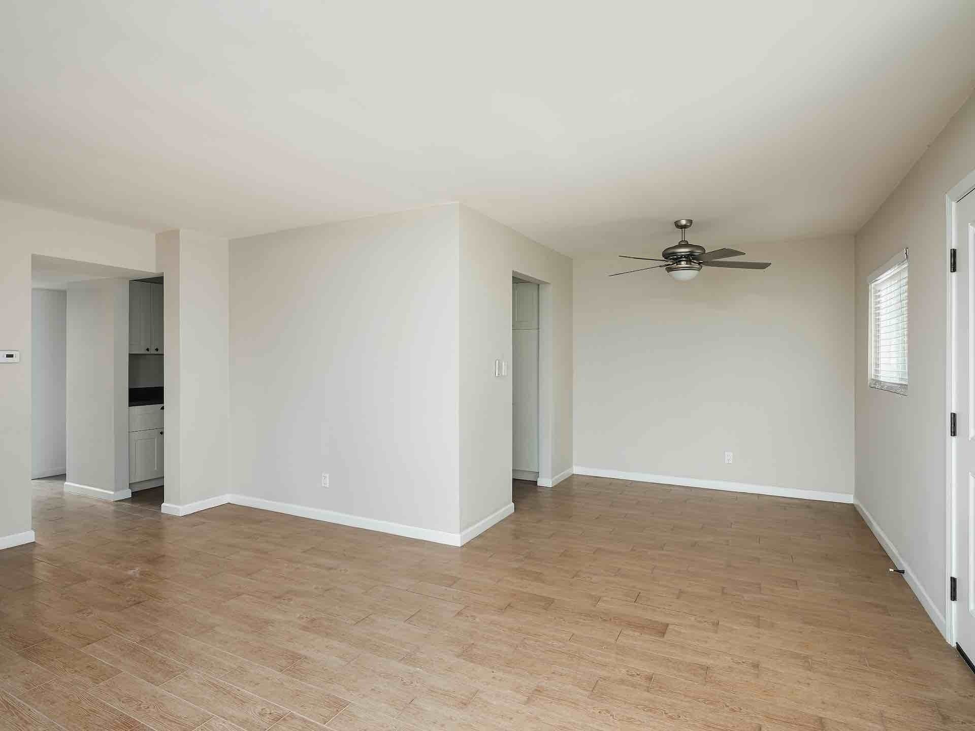 Room with small bathroom doorway and entry leading to living room