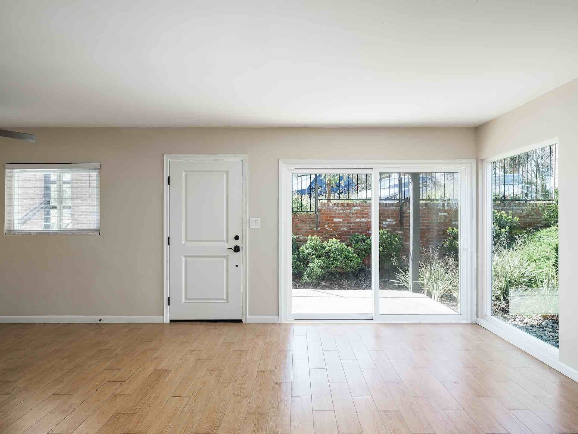 Entry of apartment with sliding glass door leading to patio and hardwood floors