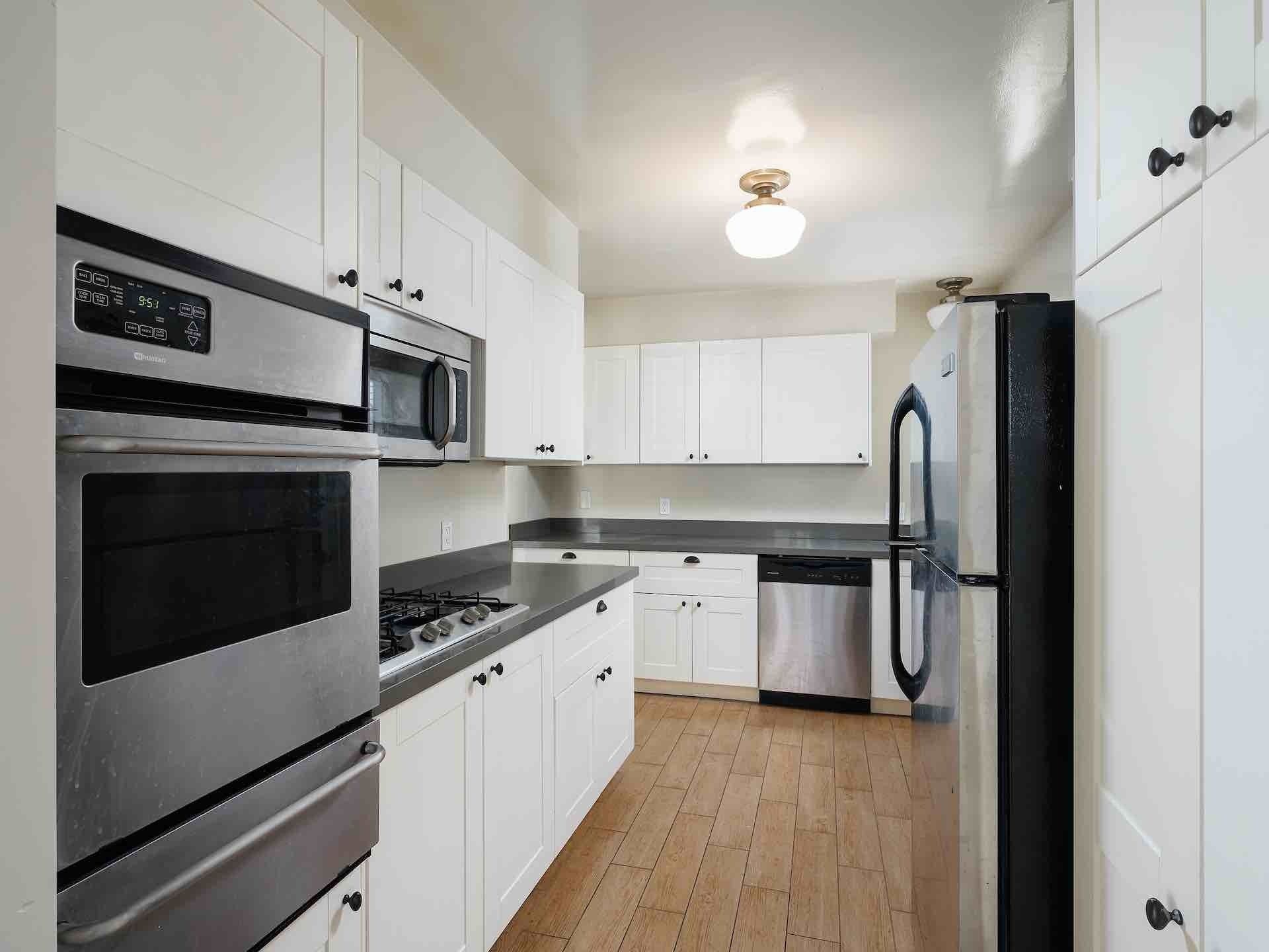 Kitchen with white cabinetry and stainless steel appliances