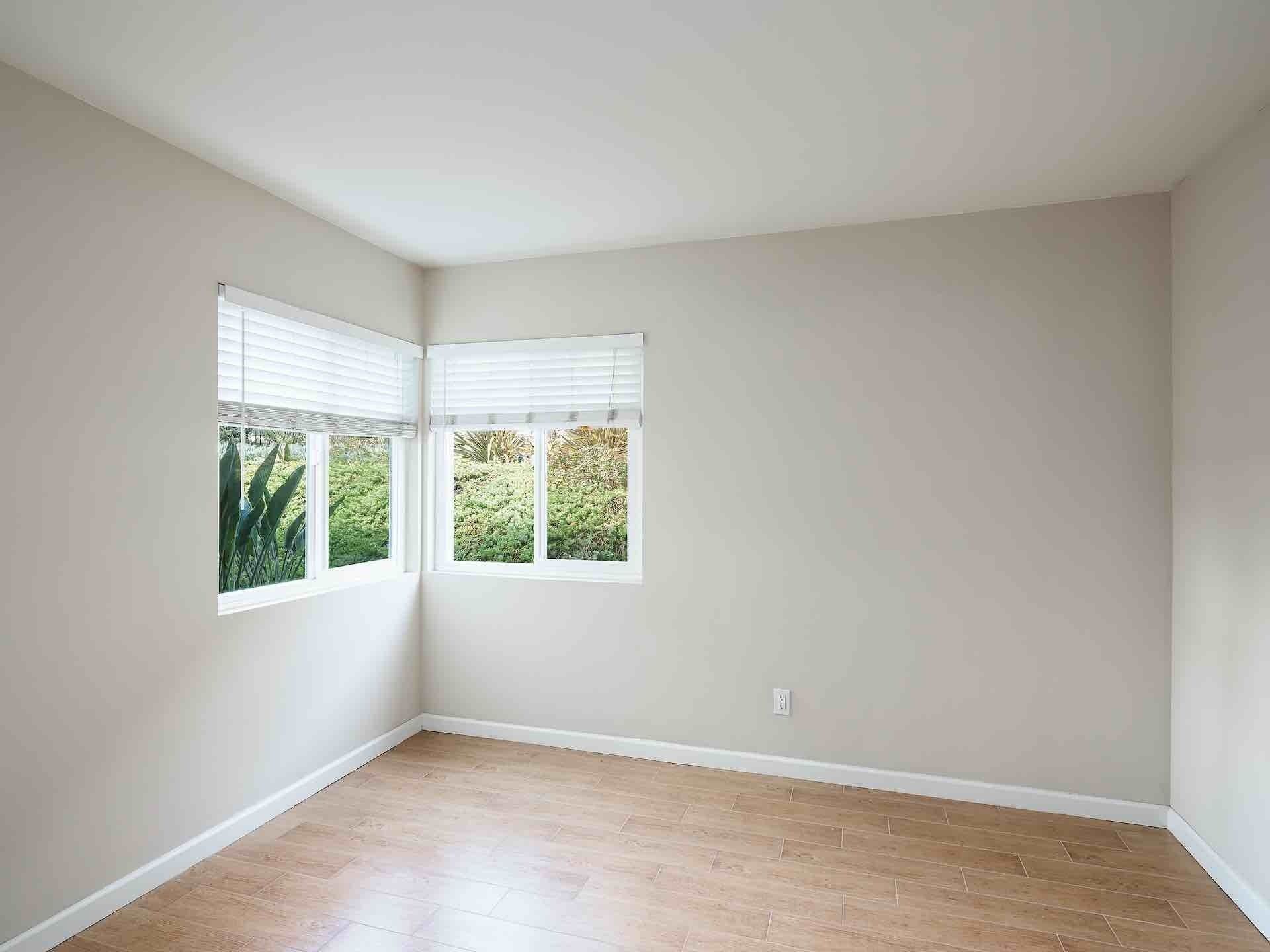 Corner of room with two windows adjacent to eachother