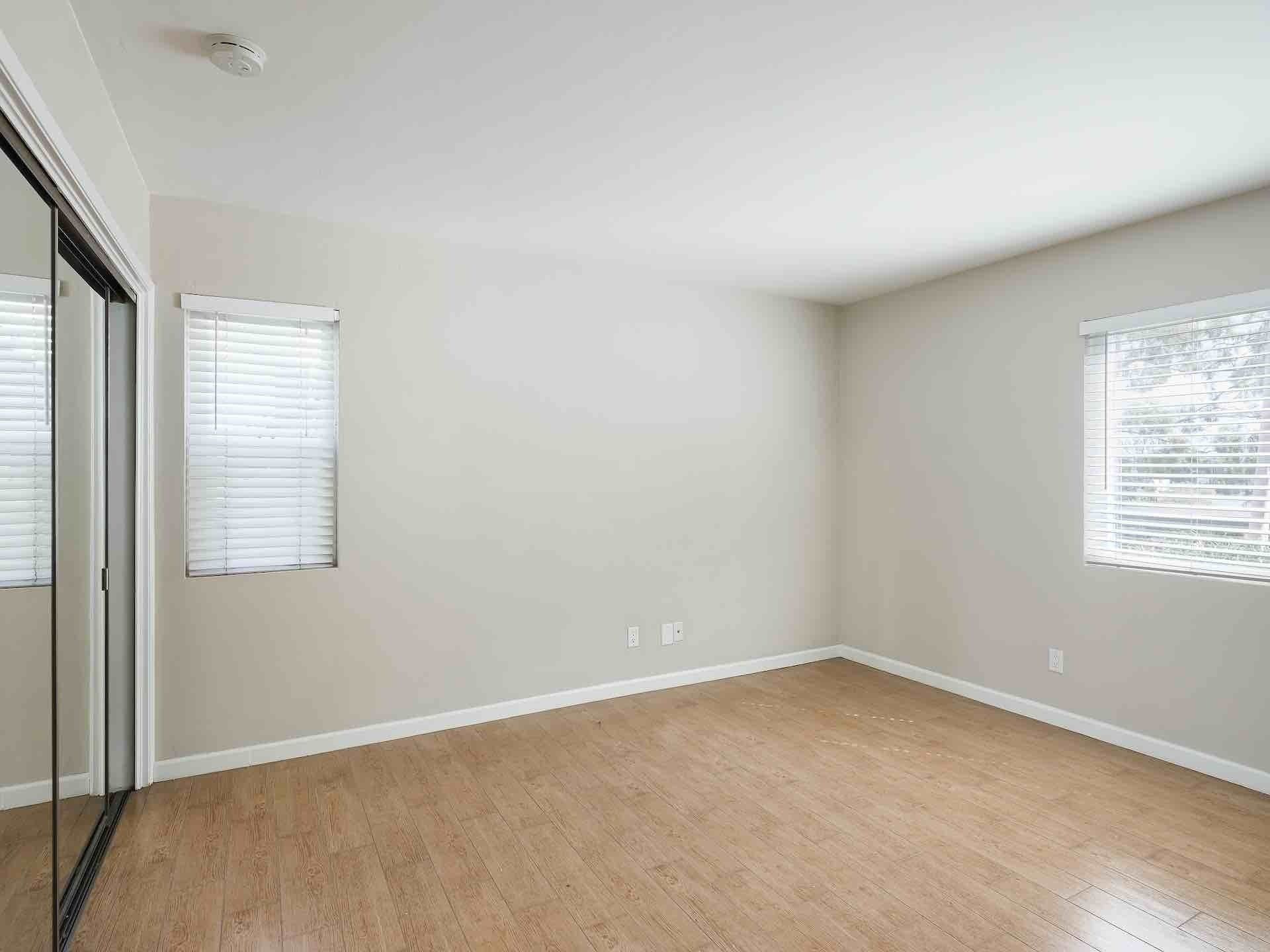 Interior of room with two windows and hardwood floors