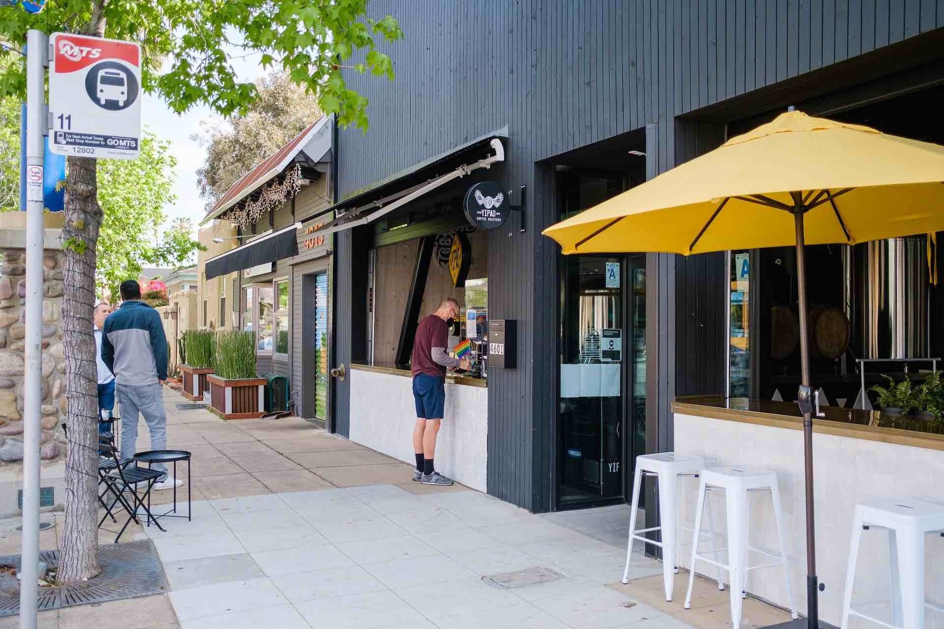 Businesses downtown storefronts with yellow umbrella out front