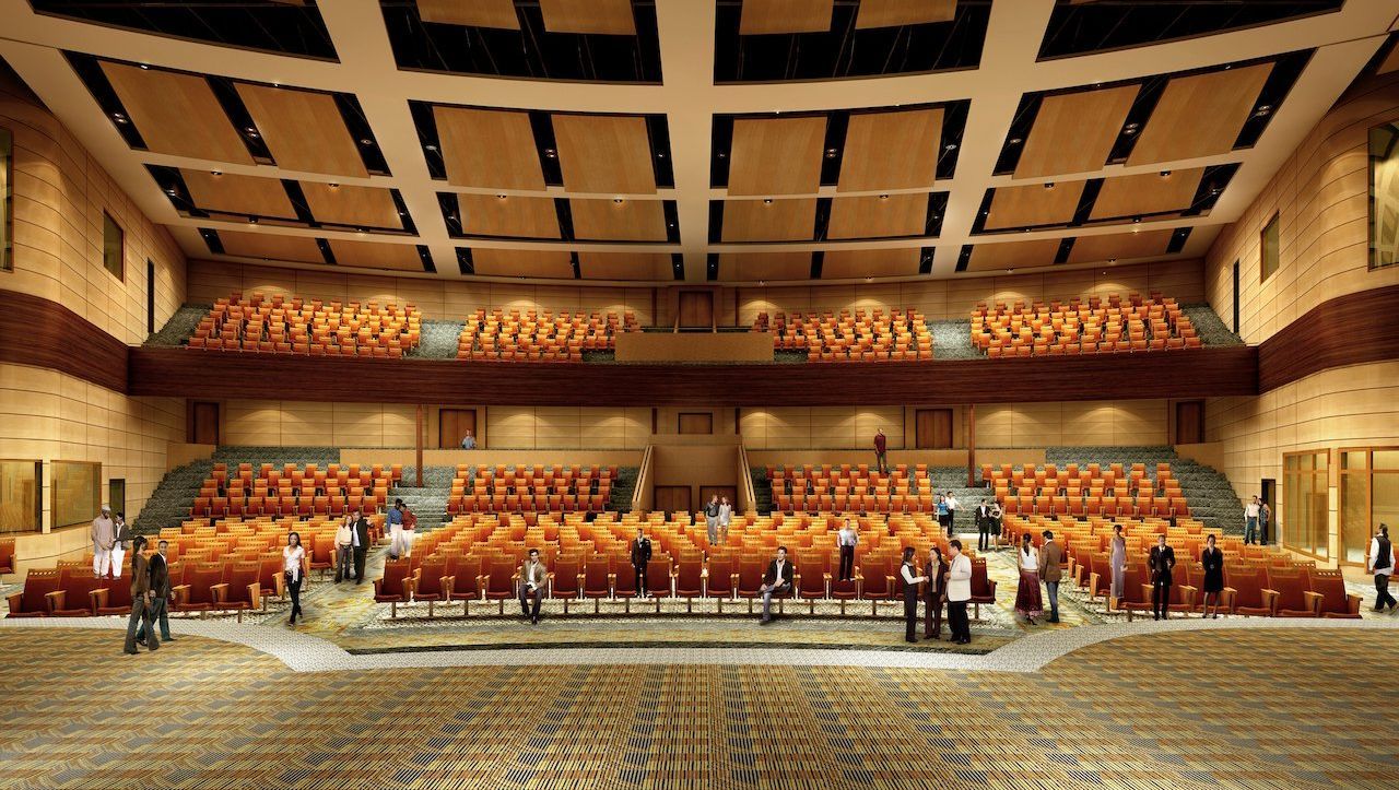 An artist 's impression of a large auditorium with orange seats