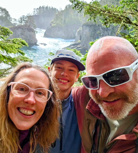 Victoria Bentley posing for a picture  with her family with a river in the background.